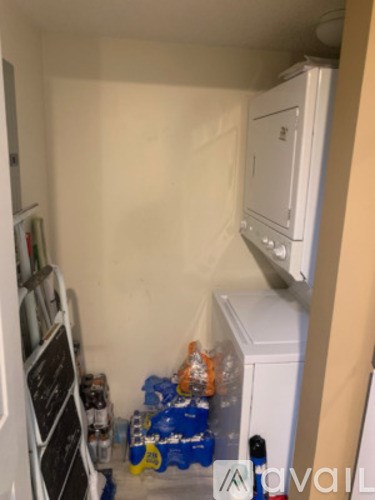 A small kitchen with a white fridge and a white oven.