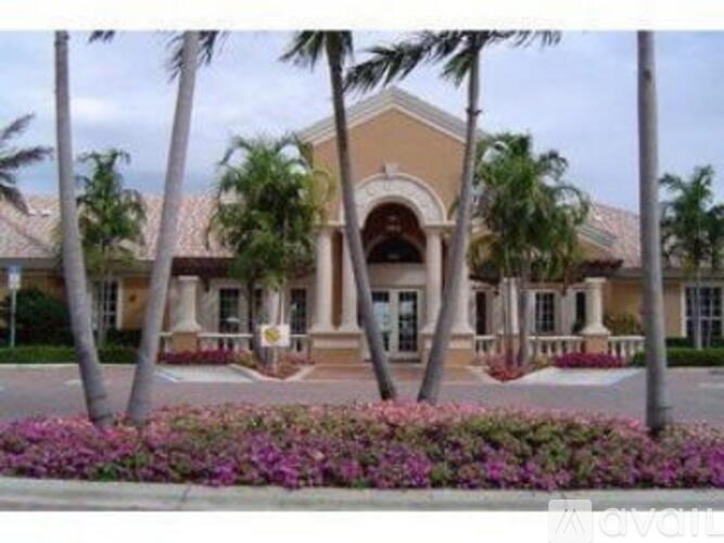 A building with a palm tree in front of it.
