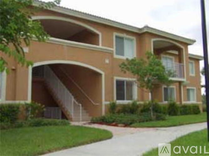 A two-story apartment building with a balcony on the second floor.