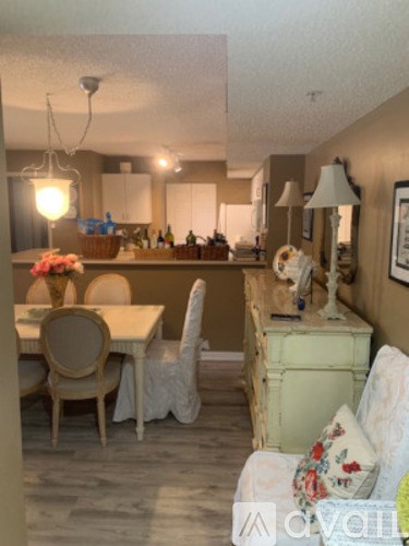 A dining room with a table and chairs.