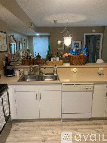 A kitchen with white cabinets and a sink.