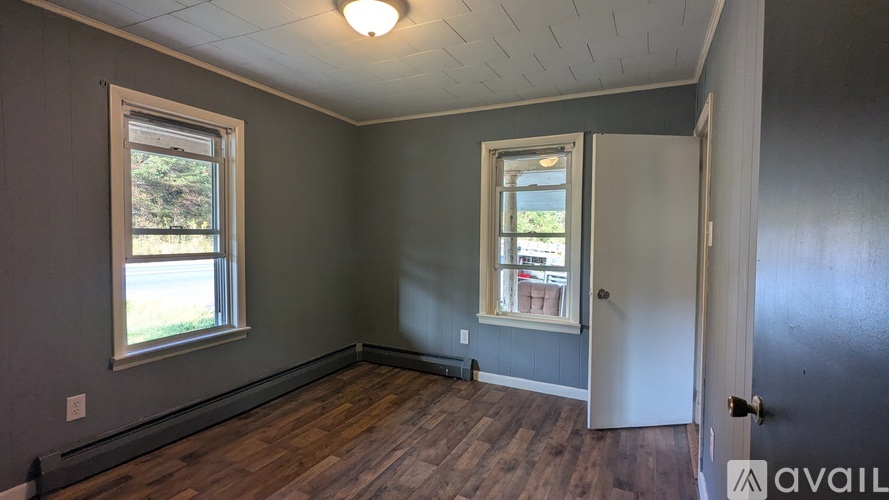 A room with a door, a window, and a wall.