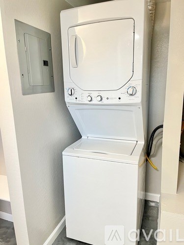 A white washing machine in a small room.