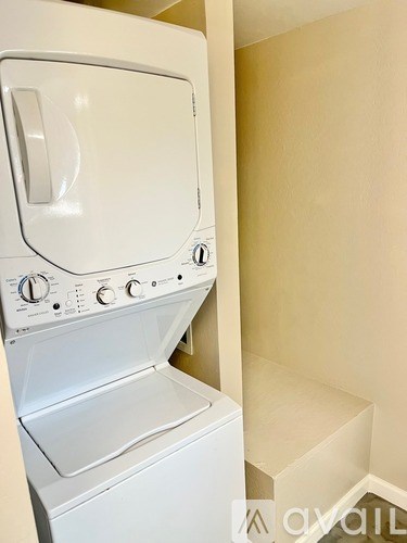 A white dryer is in a small room.