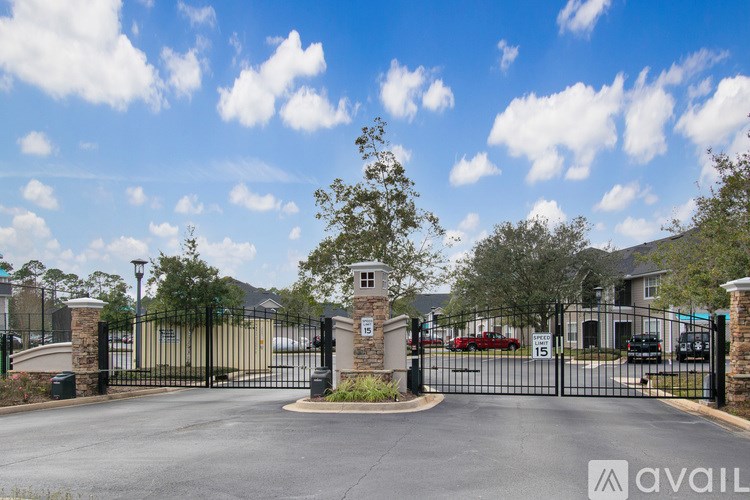A gated entrance to a residential area with a sign that reads "avail".