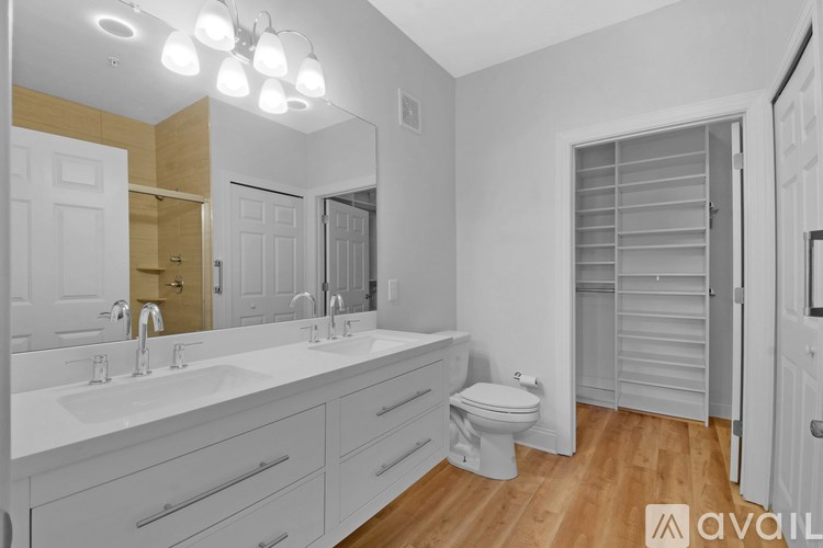 A bathroom with a white sink and a toilet.