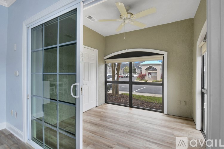 A room with a glass door leading to a balcony.