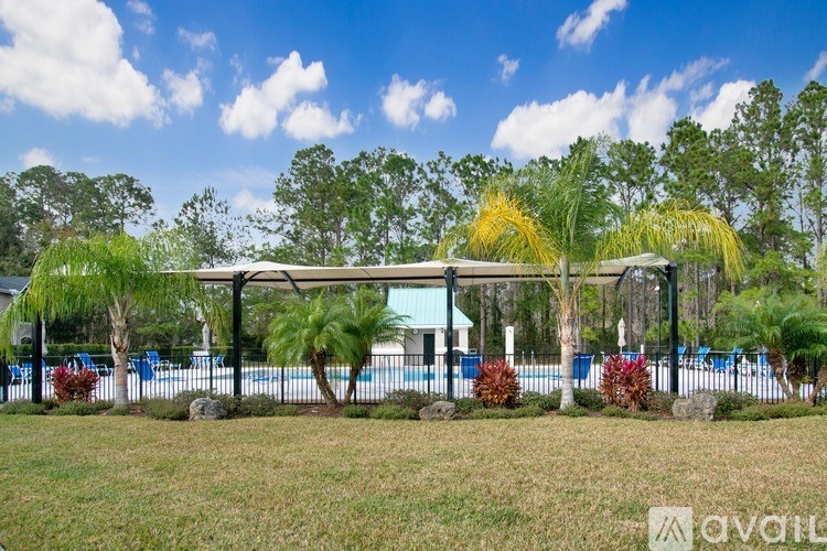 A pool area with a pavilion and trees.