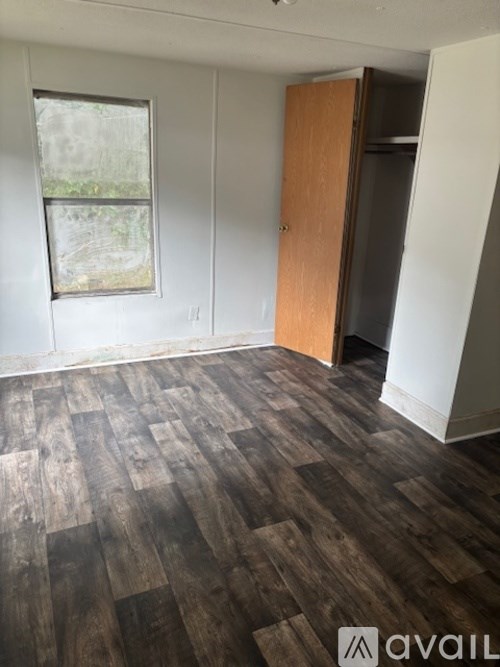 A room with a wooden floor and a door.