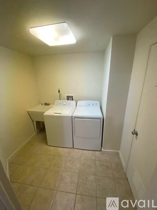 A small bathroom with a washer and dryer.