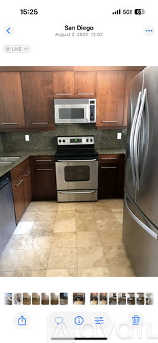 A kitchen with a stove, refrigerator, and microwave.