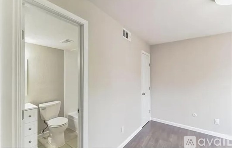 A bathroom with a toilet and a mirror.