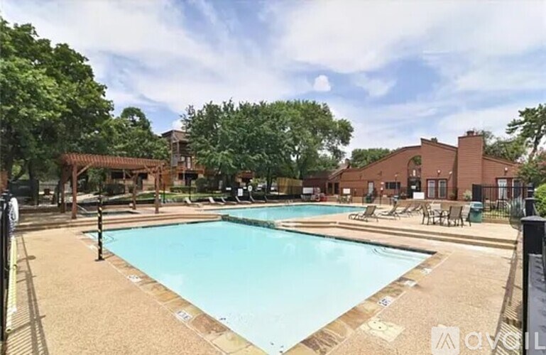 A large outdoor swimming pool surrounded by a fence.