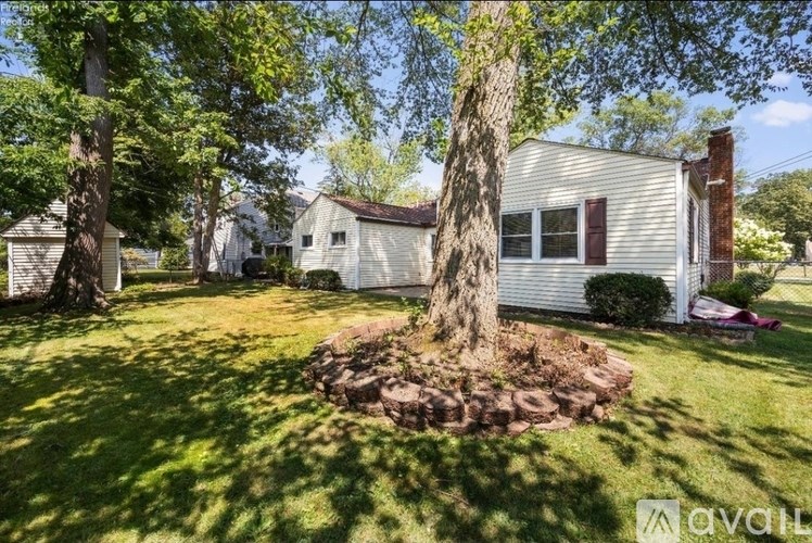 A house with a tree in front of it.