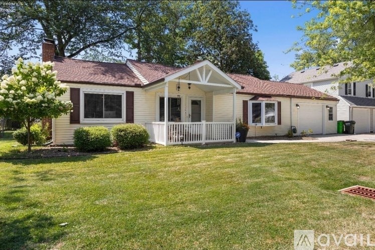 A house with a red roof and a white porch.