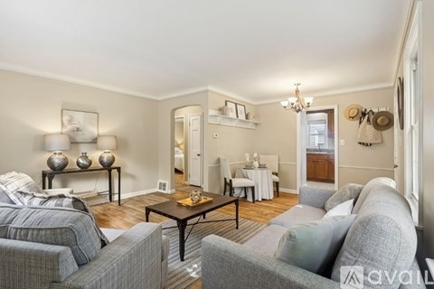 A living room with a grey couch and a coffee table.