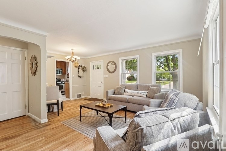 A living room with a grey couch and a wooden coffee table.
