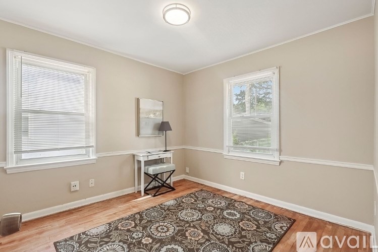 A room with a desk and a chair in it.