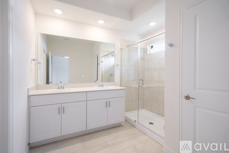 A bathroom with a white door and a white sink.