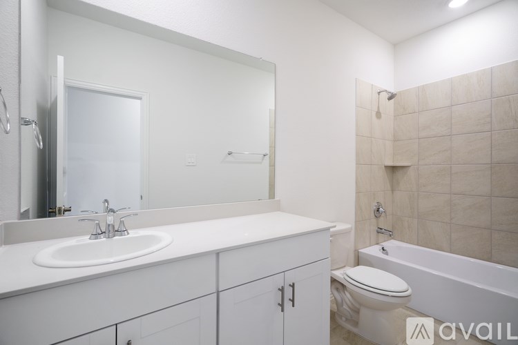 A white bathroom with a sink, toilet, and bathtub.