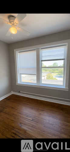 A room with a ceiling fan and a window.