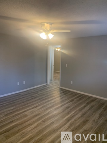 A room with wooden flooring and a light on.