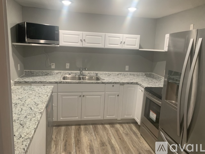 A kitchen with granite countertops and stainless steel appliances.
