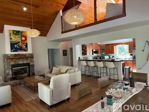 A living room with a fireplace and a painting on the wall.