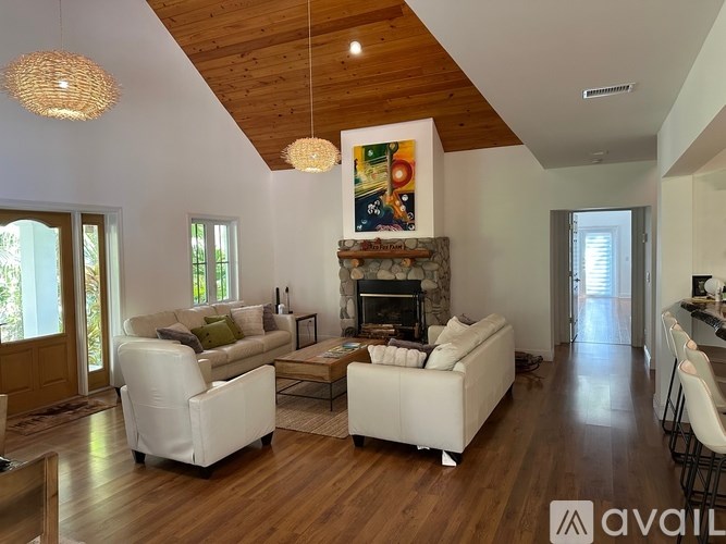A living room with a fireplace and a painting on the wall.