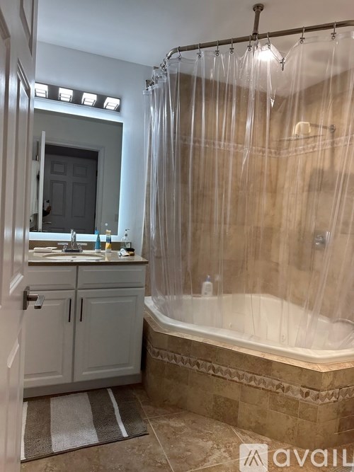 A bathroom with a tub, shower, and sink.