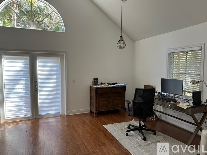 A room with a desk and a chair in it.