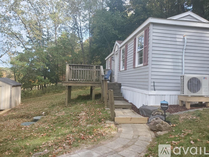 A mobile home with a deck and a covered patio area.