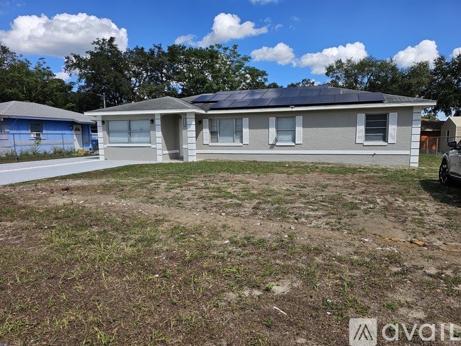 A house with solar panels on the roof is for sale.