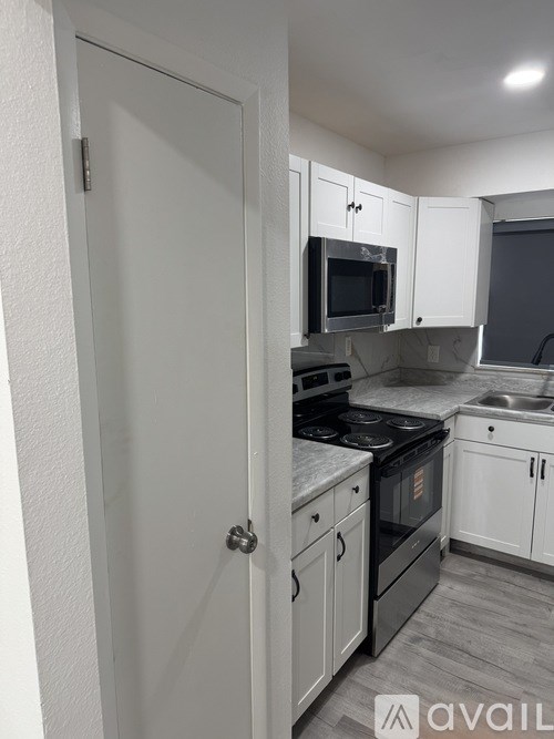 A kitchen with a stove, oven, and microwave.