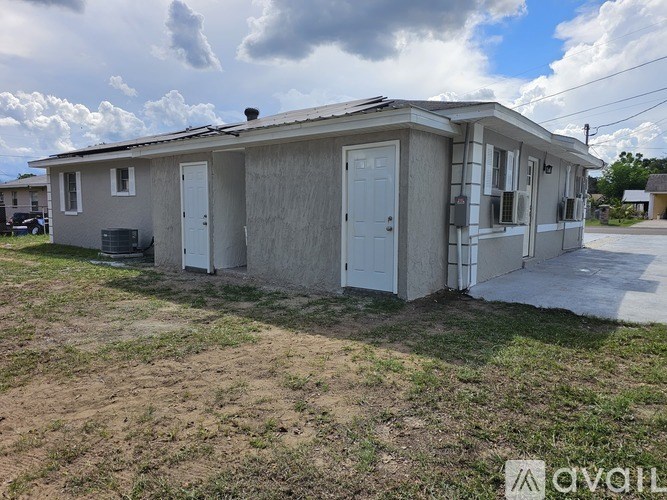 A two-story house with a white door and windows.