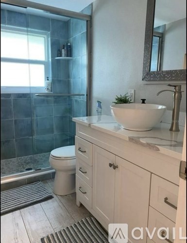 A bathroom with a white sink and a white toilet.