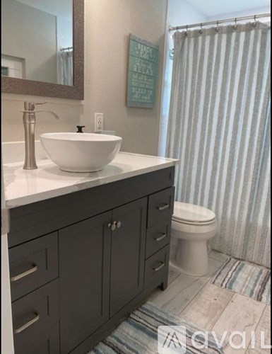 A bathroom with a white sink and a toilet.