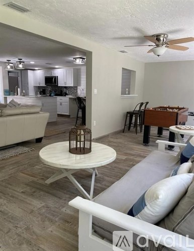 A living room with a white table and a couch.