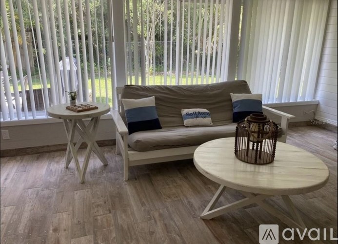 A living room with a couch, a small table, and a basket on the table.