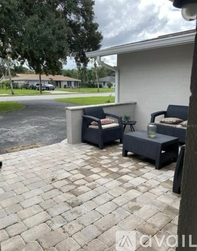 A patio with a couch and a table.