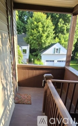 A house is visible through a window on a sunny day.