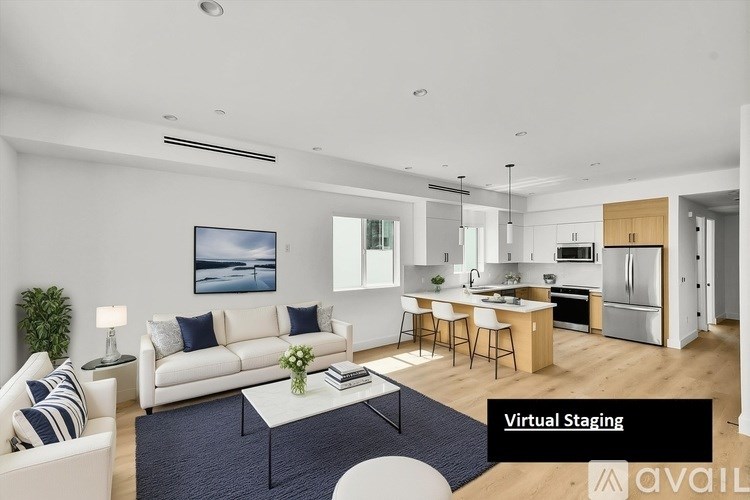 A modern living room with a white sofa and a coffee table.