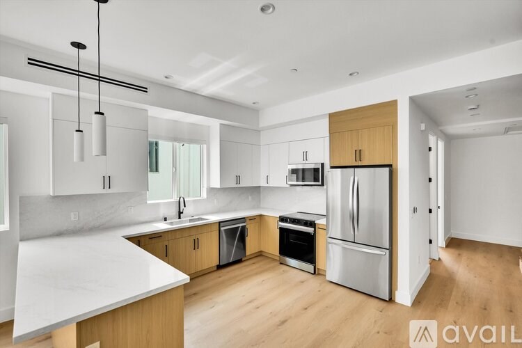 A modern kitchen with wooden cabinets and stainless steel appliances.