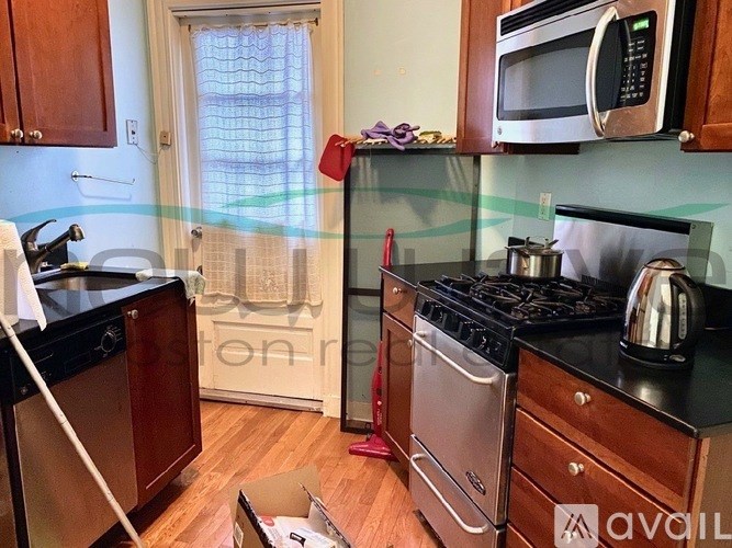 A kitchen with a stove top oven, microwave, and dishwasher.