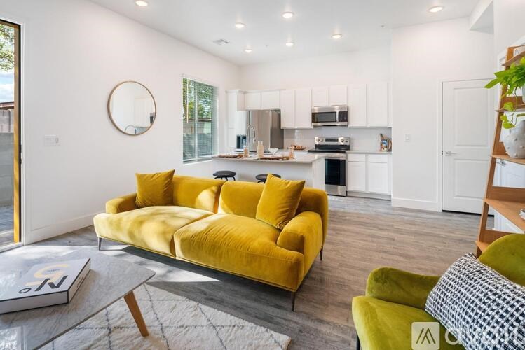 A yellow couch is in the middle of a modern living room.