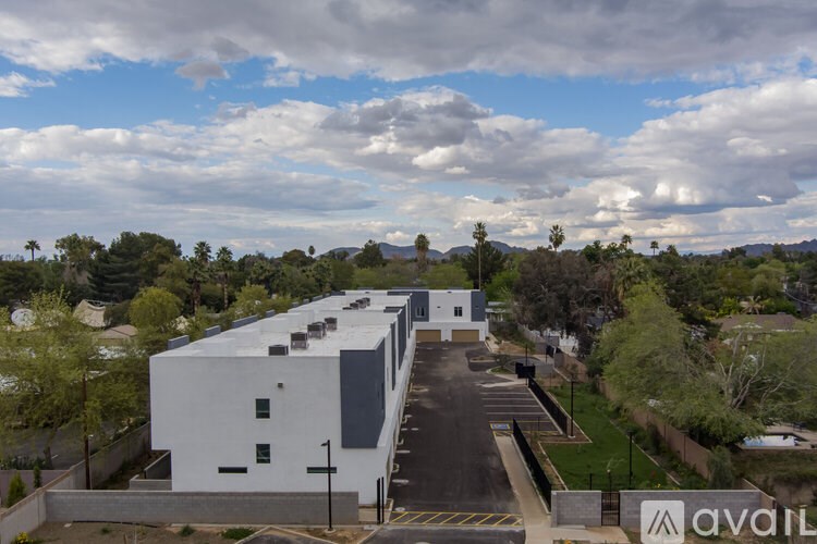 A white building with a parking lot in front of it.