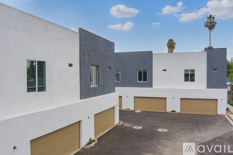 A modern building with a parking area in front.