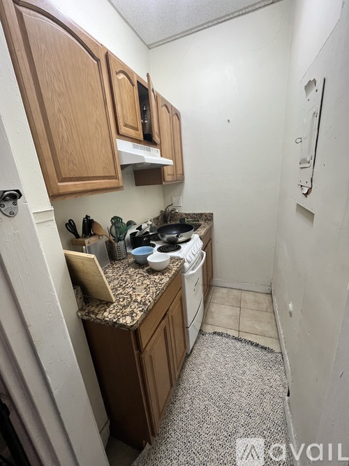 A kitchen with wooden cabinets and a granite countertop.