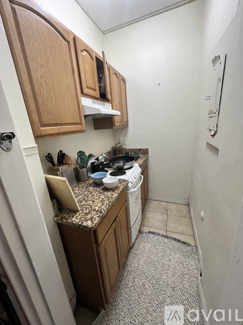 A kitchen with wooden cabinets and a granite countertop.