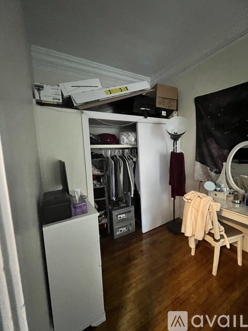 A small room with a wardrobe and a chair.